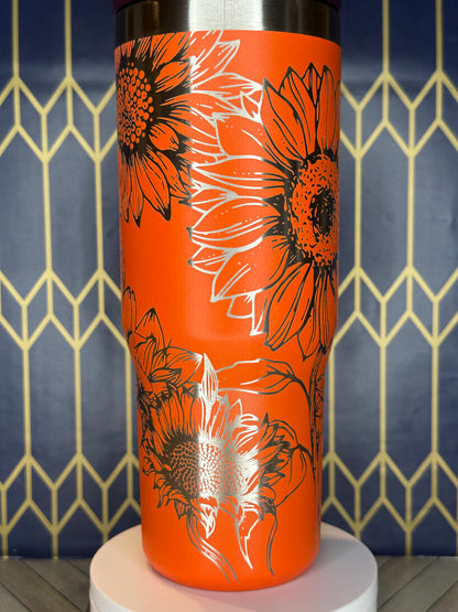 a close up of a toilet paper holder with flowers on it
